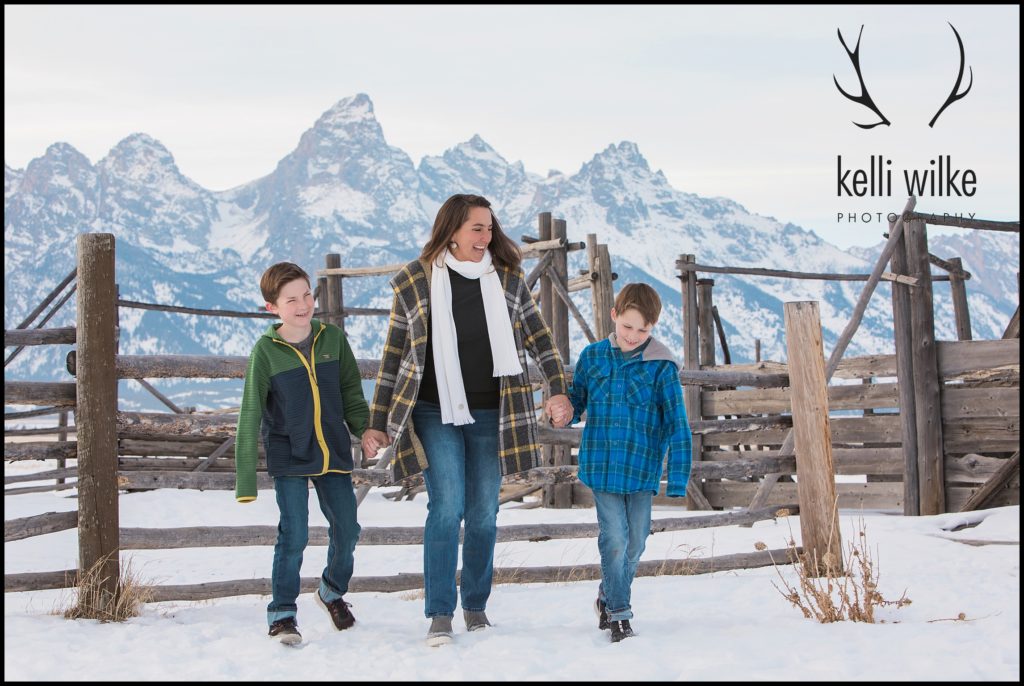 a mom with her sons in front of the Tetons family portrait