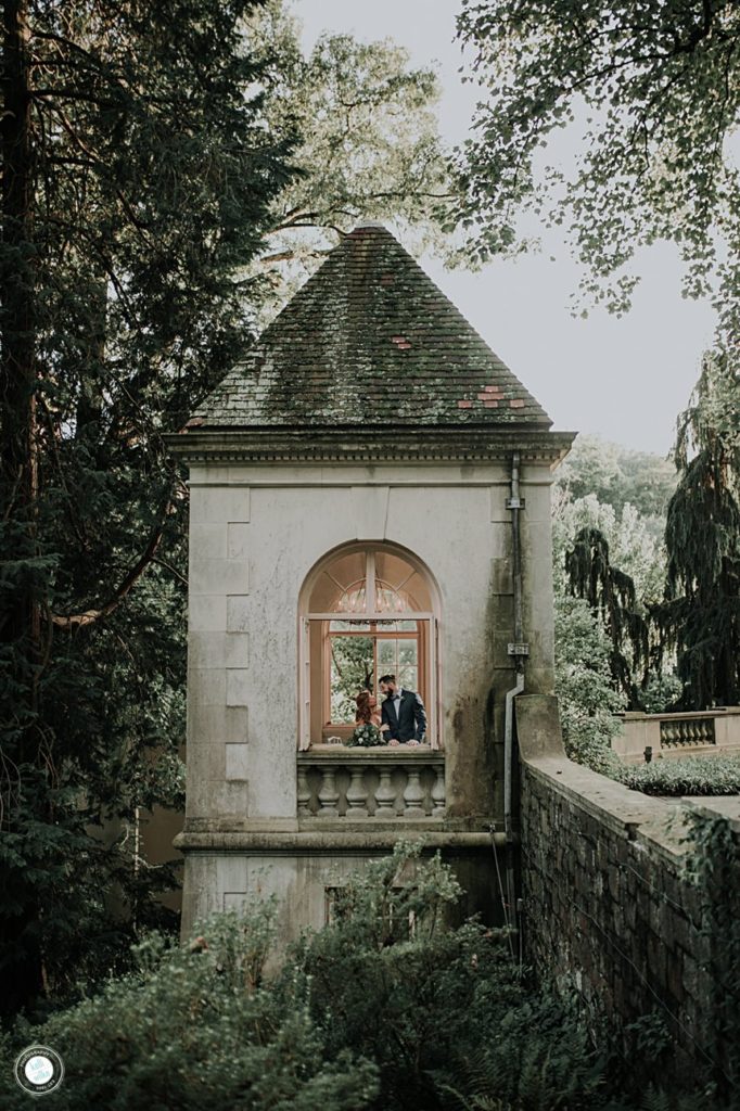 bride and groom in the kissing tower at winterthur museum and gardens in wilmington delaware