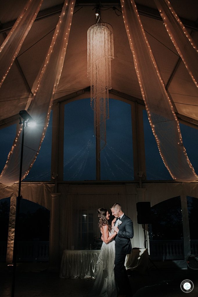 dramatic couple photo of bride and groom at penn oaks golf club tent