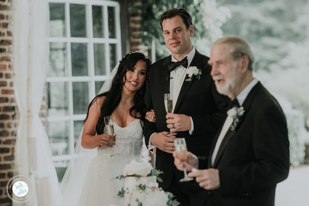 Father's speak with the bride and groom at Greenville Country Club wedding in Greenville, Delaware 