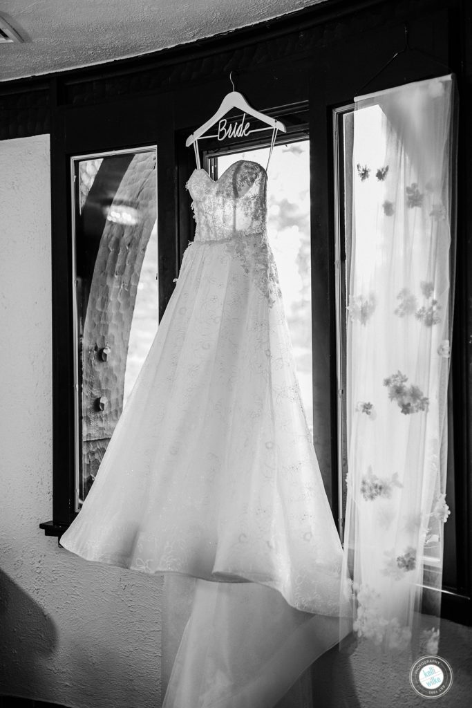 Bride's Dress made by Lazaro from Jennifer's Bridal hanging in the window with a bride hanger at Greenville Country Club in Greenville DE 