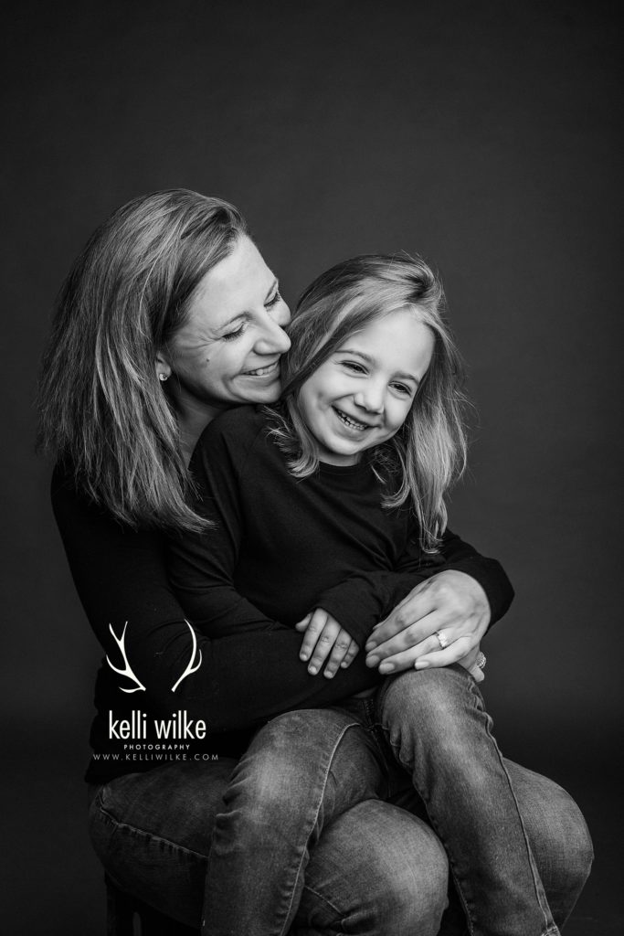 mother and daughter studio portrait in black and white
