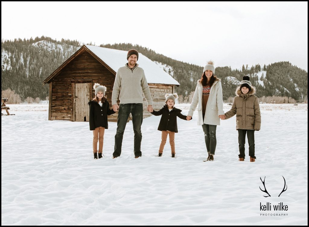 a snowy family portrait in Jackson wyoming at mormon row