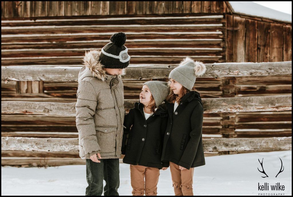 children at a barn in Jackson wyoming family portraits