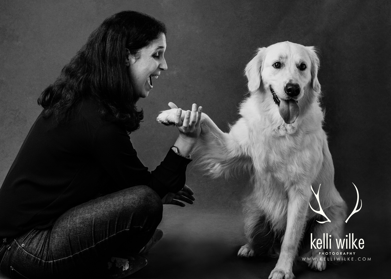 A black and white portrait of a woman with a Golden Retriever during a pet portrait session with Kelli Wilke Photography in Wilmington, Delaware. 