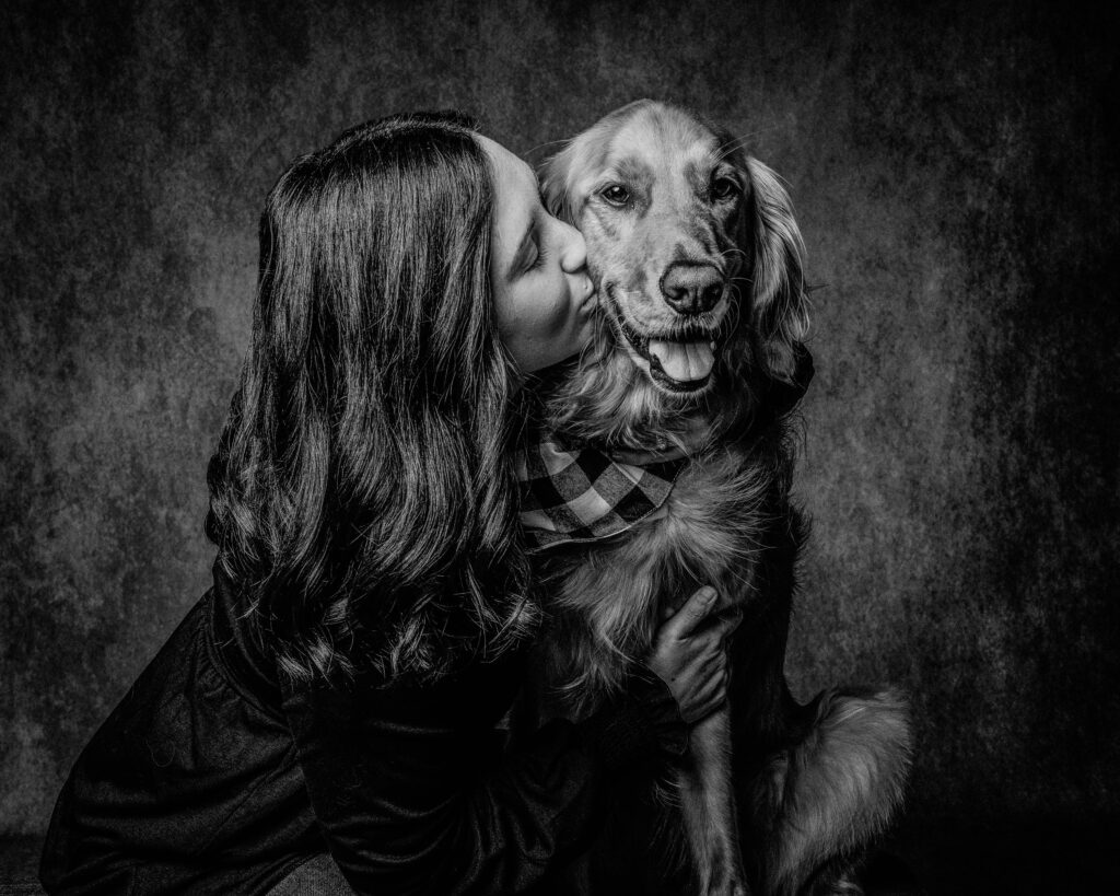 black and white photo of woman and her golden retriever dog